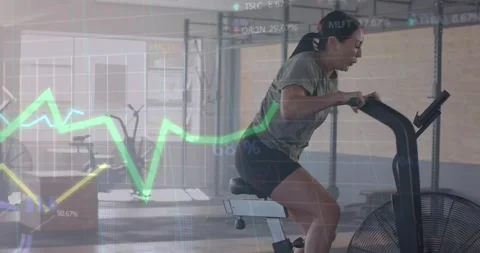 Animation of data processing on graph over woman cross training on elliptical at Stock Footage 329284278