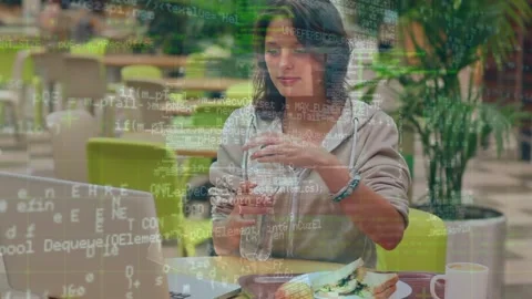 Animation of data processing over caucasian woman using laptop at bar Stock Footage 327123880
