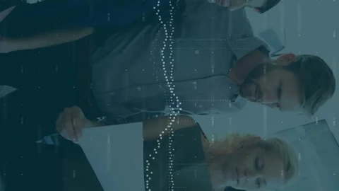 Animation of data processing over diverse team of colleagues reading documents Stock Footage 312583076