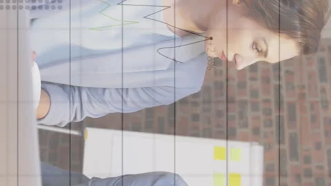 Animation of data processing over diverse business people using computer Stock Footage 312620384