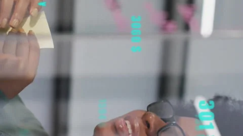 Animation of data processing over woman taking notes in office Stock Footage 312876434