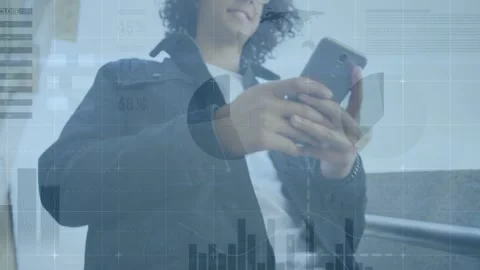 Animation of digital graphs and database moving over man using smartphone in Stock Footage 329919691