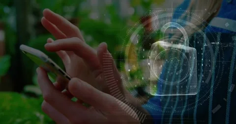 Animation of digital padlock over hands of caucasian woman using smartphone 库存影片 329971230