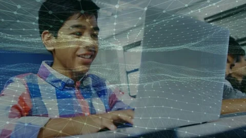 Animation of digital waves over indian boy using laptop in the class at school Stock Footage 326764451