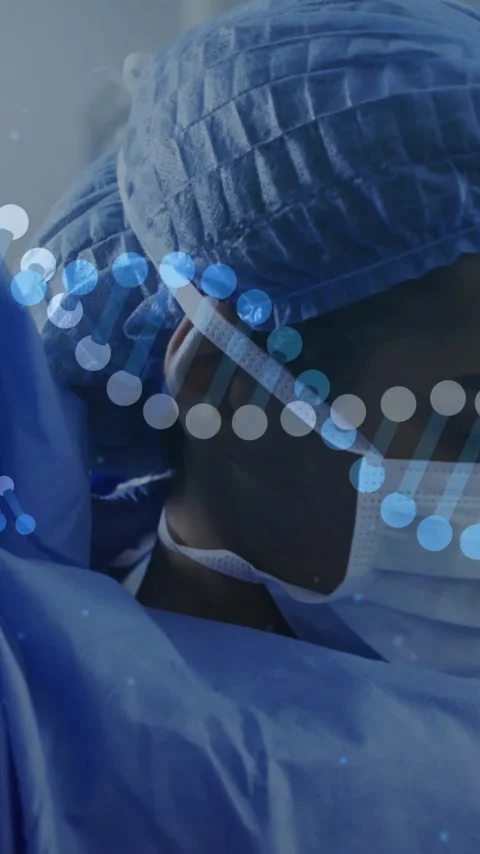 Animation of dna strands over diverse surgeons wearing face masks in operating Stock Footage 342915727