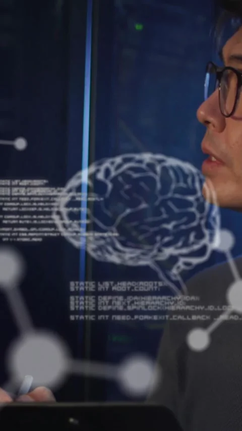 Animation of elements, brains and data processing over asian male technician Stock Footage 344370227