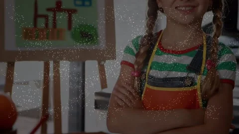 Animation of falling confetti over caucasian girl at art class Stock Footage 330057849