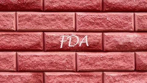 Animation of the FDA text on a brick wall. Food and Drug Administration. FDA Stock Footage 316875352