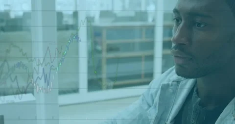 Animation of financial data over african american designer using computer in Stock Footage 330254217