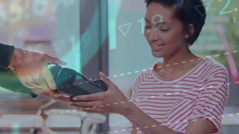 Animation of financial data processing over biracial woman paying at payment Stock Footage 220378619