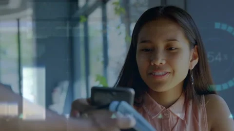 Animation of financial data processing over woman paying at payment terminal Stock Footage 327525110