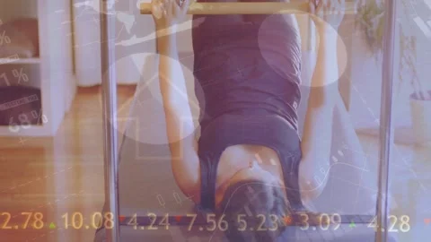 Animation of financial data processing over exercising women Stock Footage 329923508