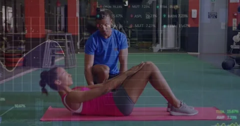 Animation of financial data processing over woman exercising in gym 動画素材 329926966