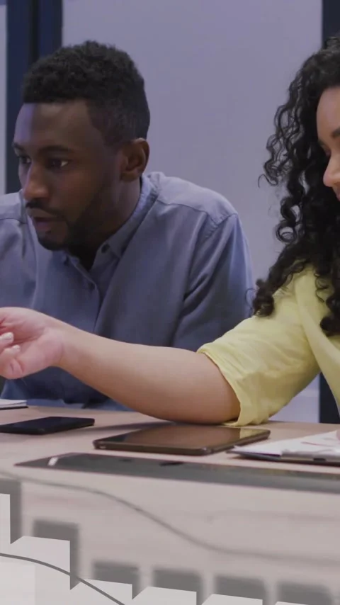 Animation of financial data processing over diverse colleagues discussing work Stock Footage 343868100