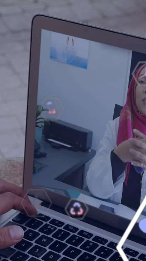 Animation of financial data processing over woman in hijab on laptop video call Stock Footage 344783486