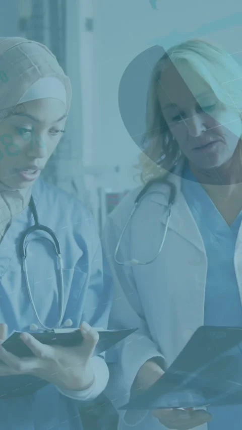 Animation of financial graphs and data over diverse female doctors with x ray Stock Footage 344011768
