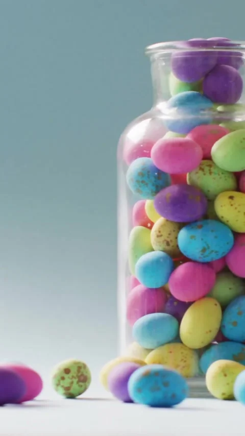 Animation of fingers with easter bunny and easter egg over jar of easter eggs on Stock Footage 343824250