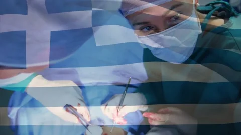 Animation of flag of greece waving over surgeons in operating theatre Stockbeeldmateriaal 162114169