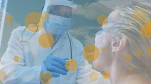 Animation of floating yellow dots over african american male doctor testing Stock Footage 329967026