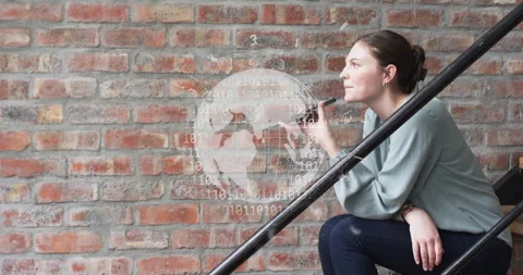 Animation of globe and binary coding over caucasian woman talking on smartphone Stock Footage 310303500
