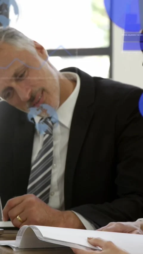 Animation of globes, graphs and computer language over caucasian coworkers Stock Footage 344557869