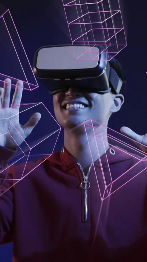 Animation of glowing 3d shapes over asian man using vr headset Stock Footage 319513828