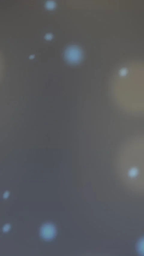Animation of glowing blue spots against spots of light against grey background Stock Footage 344402964