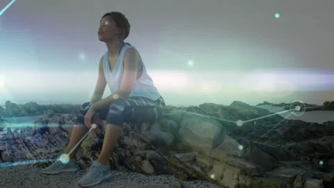 Animation of glowing communication network over woman resting after exercise on Stock Footage 164575428