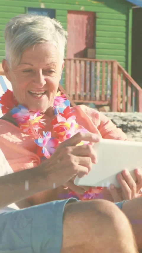 Animation of glowing light over portrait of happy senior couple using tablet in Vídeo Stock 342097443
