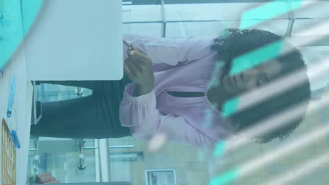 Animation of graph, globe and computer language over diverse coworkers Stock Footage 313424824