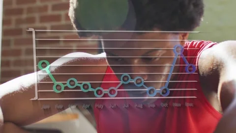Animation of graph over african american man at gym Stock Footage 327448235