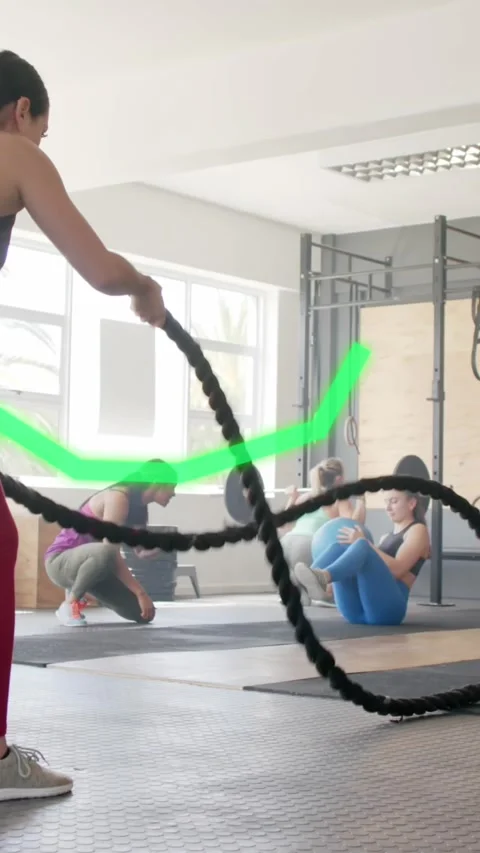 Animation of graph processing data over caucasian woman cross training with Stock Footage 323783028