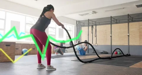 Animation of graph processing data over caucasian woman cross training with Stock Footage 328707836