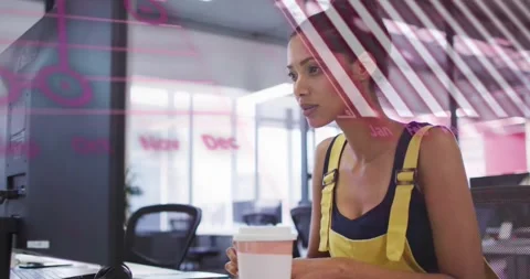 Animation of graphs, globe and computer language over woman working on computer Stock Footage 328315945