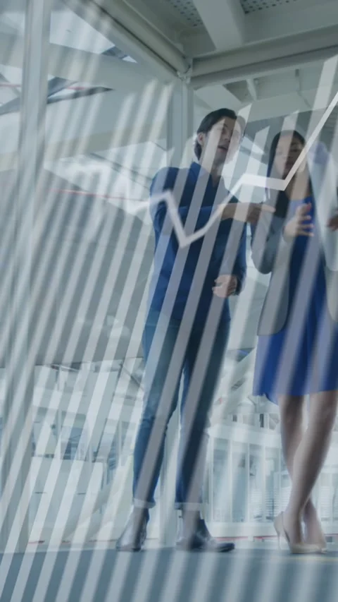 Animation of graphs over diverse architects gesturing and discussing building Stock Footage 344774967