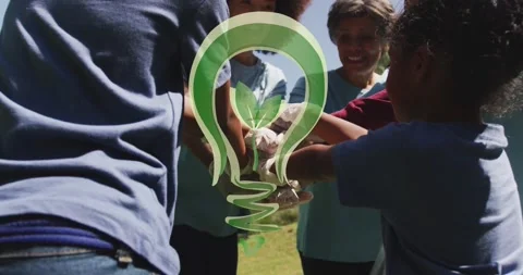 Animation of green light bulb logo over happy african american group stacking ha Stock Footage 170015470
