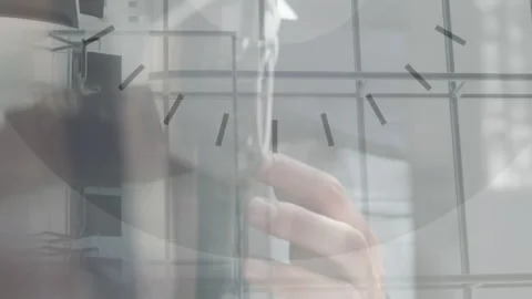 Animation of hand of caucasian man using computer over clock moving Stock Footage 312532590