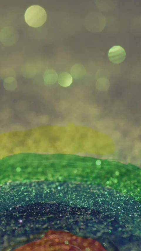 Animation of hand painted rainbow over glowing sand falling in background Stock Footage 343714563