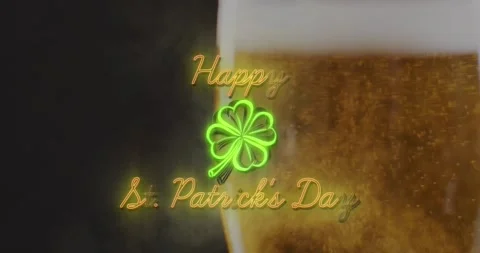Animation of happy st patrick's day with clover icon over glass of beer Stock Footage 328969844