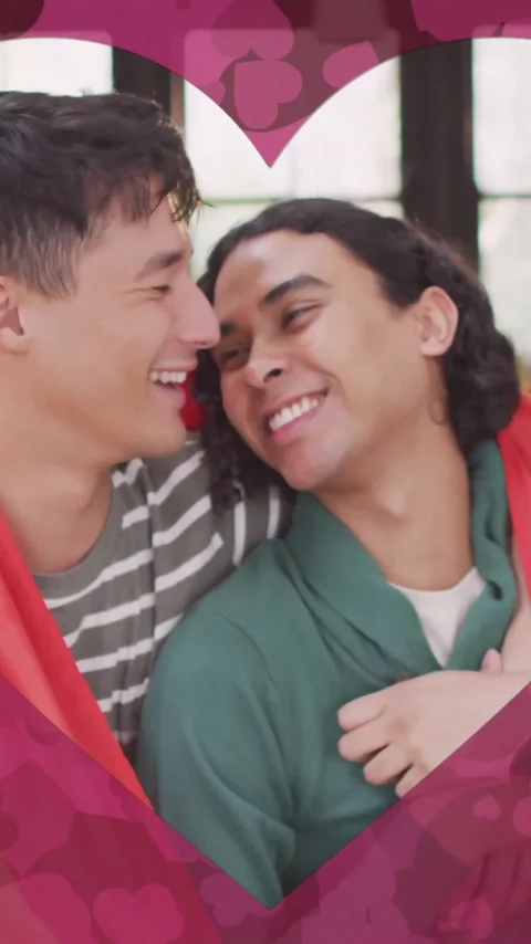 Animation of heart cut out over happy diverse gay male couple embracing in Vídeo Stock 343610305