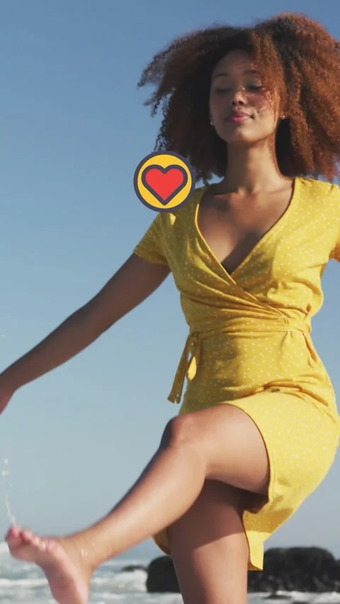 Animation of heart digital icons over woman dancing on beach Stock Footage 331649688