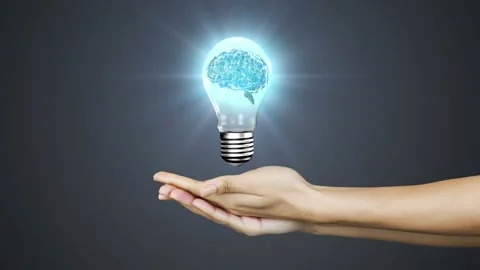 Animation of human brain spinning in a light bulb icon over cupped hands against 스톡 동영상 330728646