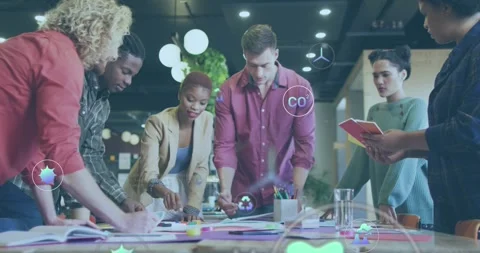 Animation of icons and computer language over diverse coworkers creating product Stock Footage 327583826