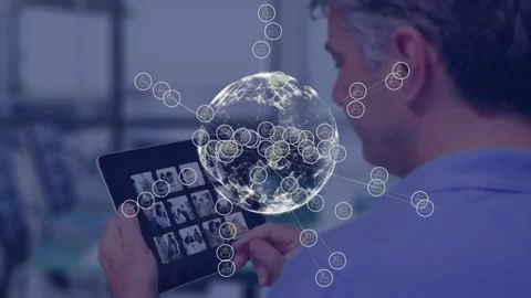 Animation of icons around globe over caucasian man looking at pictures in Stock Footage 330407703