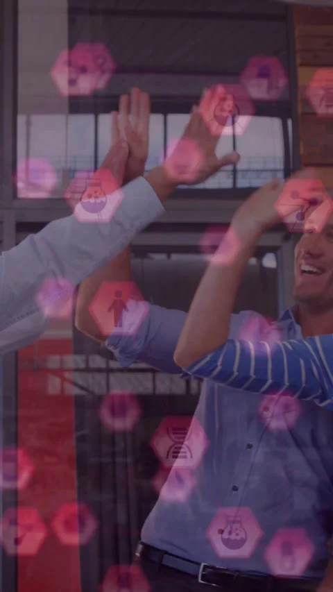 Animation of icons floating over happy diverse coworkers clapping hands in Stock Footage 322954363