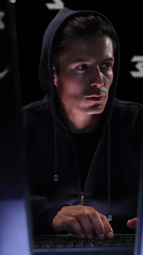 Animation of icons over caucasian hacker using computer Stock Footage 342004372