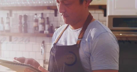 Animation of infographic interface over asian man wearing apron using digital Stock Footage 326189137