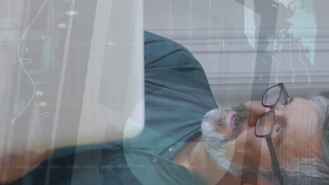 Animation of infographic interface over caucasian man wearing spectacles working Stock Footage 312442503