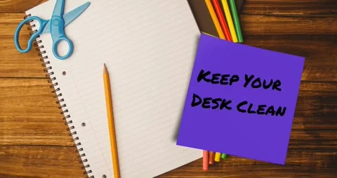 Animation of keep your desk clean text on memo note over notebook and pencils on Stock Footage 328164586