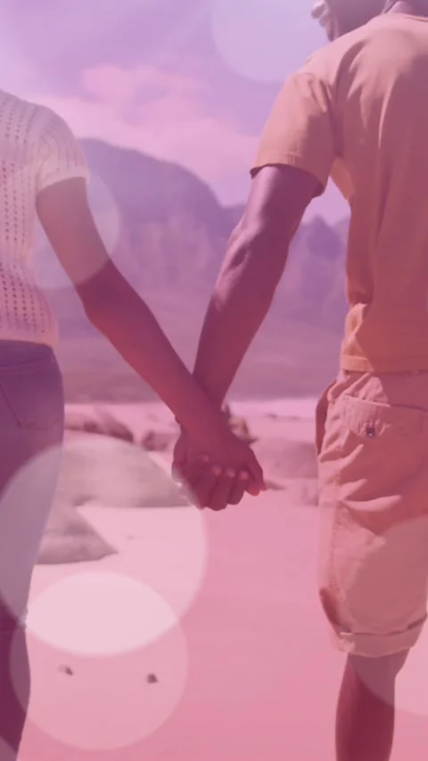 Animation of light spots over african american couple walking and holding hands Vídeo Stock 342315922